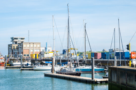 Harbor in Ostende, Belgium with ships, yachts, buildings, sea.