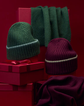 Warm winter accessories on red gift boxes