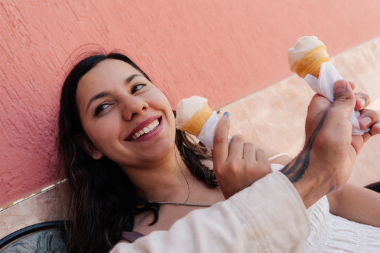 Young woman smiling and holding an ice cream cone