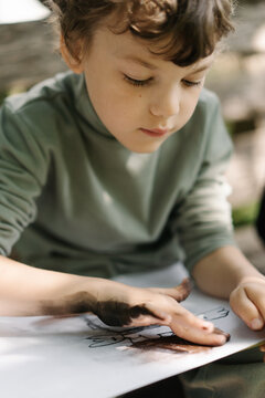 Young boy discovering joy through colorful art creation