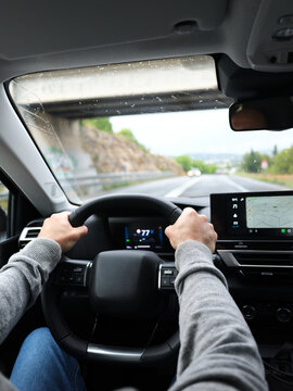 Person driving car on highway using navigation system