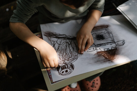 Small artist enjoying creative outdoor playtime