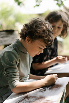 Little boy expressing imagination through colorful drawings