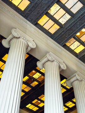 Classic stone columns under decorative ceiling with warm lights