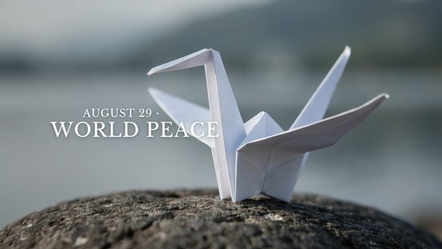 Origami paper crane on a rock for World Peace Day on August 29