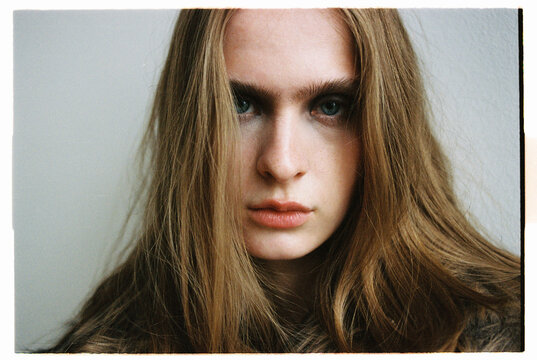Fashion model closeup with long hair in a simple setting taken on film