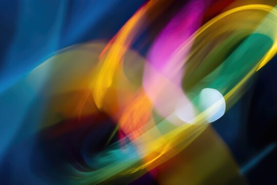 A close-up of an abstract, colorful painting with blurred edges and swirling colors, representing the concept of joy in motion.
