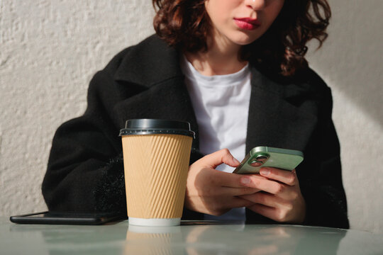 Young woman text messaging outdoors
