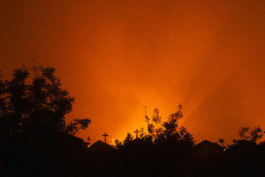 Silhouettes Against an Orange Night Glow