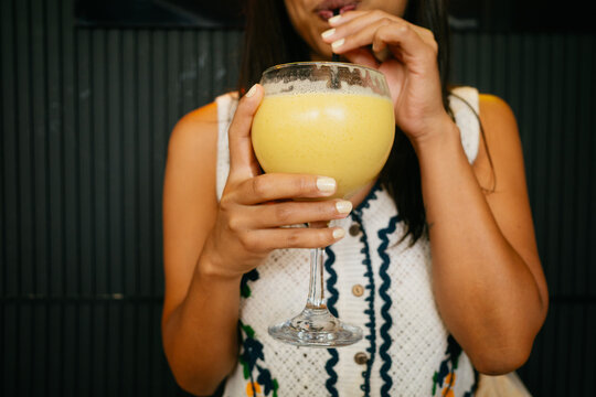 Woman Enjoying a Mango Smoothie