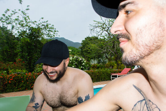 Friends Enjoy Time by the Pool During a Sunny Day at the Garden