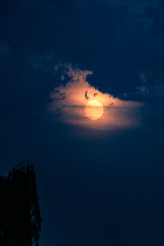 Moon Breaking Through Dark Clouds