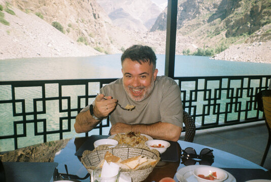 Man Enjoys Pilaf by the Gushor Lake in Tajikistan