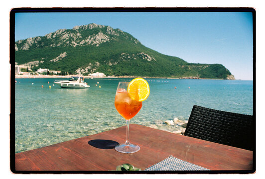 An Aperol Spritz on a waterfront table overlooking the Adriatic