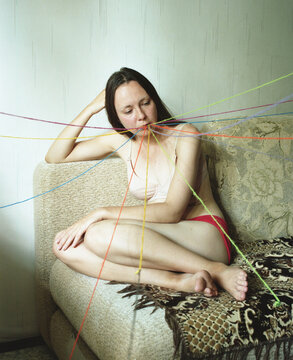 Conceptual portrait of a woman with threads