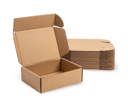 Cardboard mailer boxes displayed with flat packed boxes, shipping packaging isolated on white background