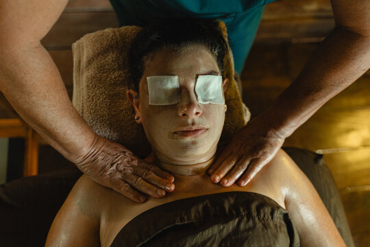 Client enjoying a facial mask and shoulder massage
