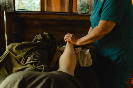 Professional giving leg and foot massage for wellness