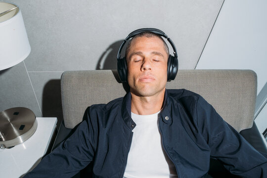 Sleeping with headphones in airport lounge