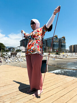 Woman Doing Yoga On The Pier