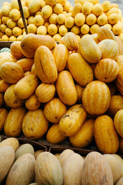 Vibrant Display of Unique Melons at a Bustling Local Market