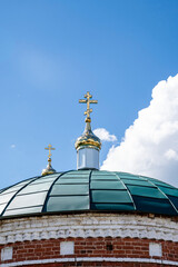 Golden crosses and domes of an Orthodox church against a blue sky © Max