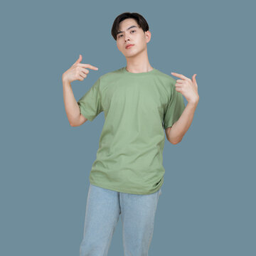 Young man points to himself with a confident expression on a blue background