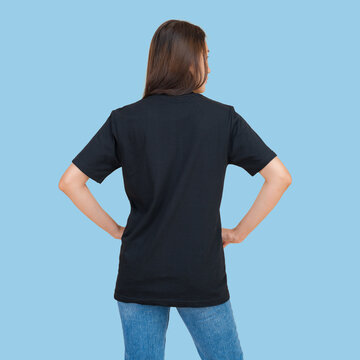 Woman wearing a plain black t-shirt and blue jeans, viewed from the back