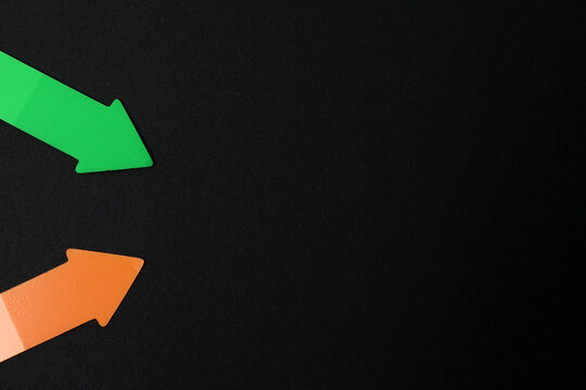 Paper arrow on color background, top view