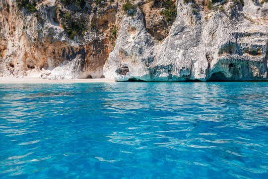 secluded cove beach in Gulf of Orosei, point of interests, tourism, amazing turquoise waters, boat tours, Cala Gonone, Piscine di Venere, no people