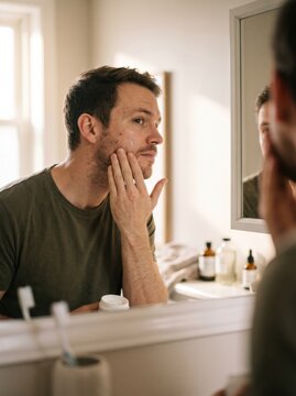 Man Applying Moisturizer in the Morning