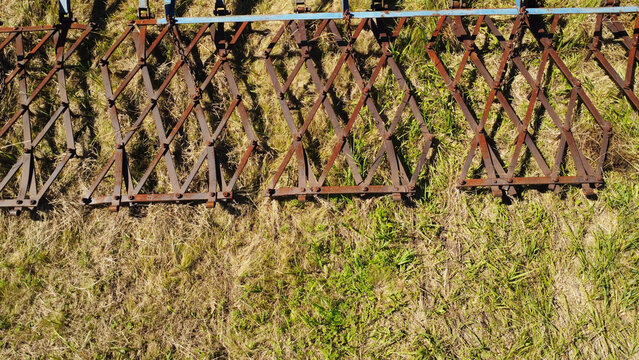 Aerial Close-Up of Wide Sectional Drag Harrow Operating on Field