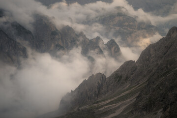 Majestic mountain peaks emerging from thick white mist. Perfect for nature and travel themes. © marcodenaro