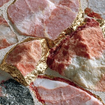 Pink terrazzo floor texture with gold seams and marble chips