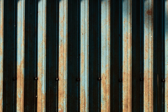 Weathered Blue Metal Gate Texture with Rusty Vertical Stripes