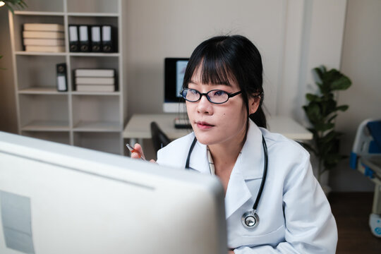 Female doctor working on computer in medical office