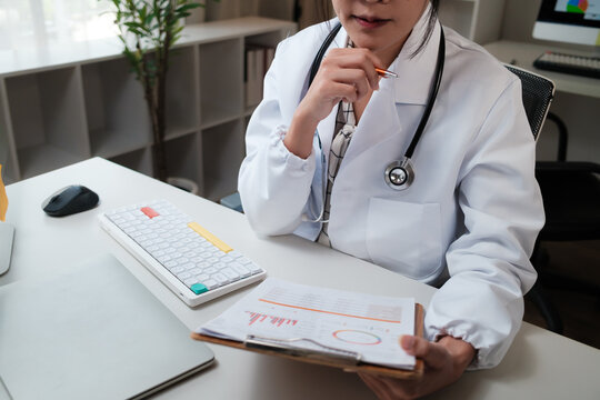 Doctor analyzing medical report data on clipboard