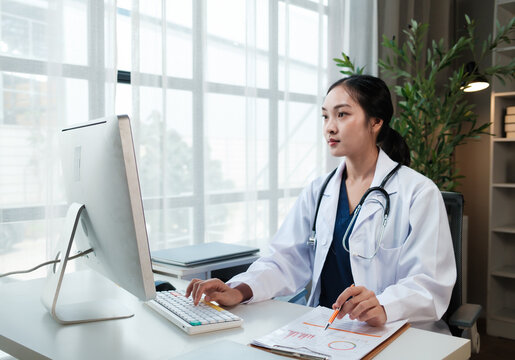 Female doctor working on computer in modern office