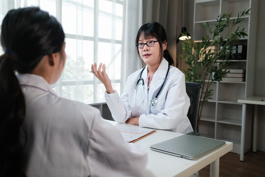 Female doctor discussing health with patient in office
