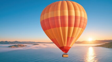 Fototapeta premium Hot air balloon floating above misty valley at sunrise with golden light