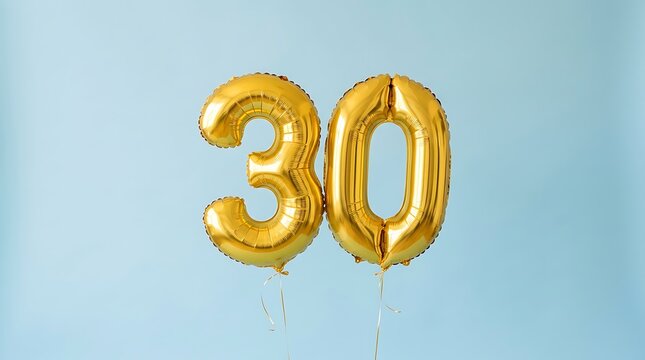 Shiny gold foil balloons in the shape of number thirty for a birthday celebration party on a soft light blue background