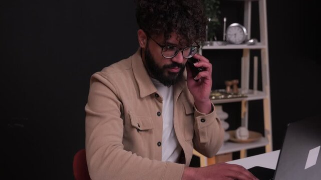 Focused male entrepreneur multitasking in modern office