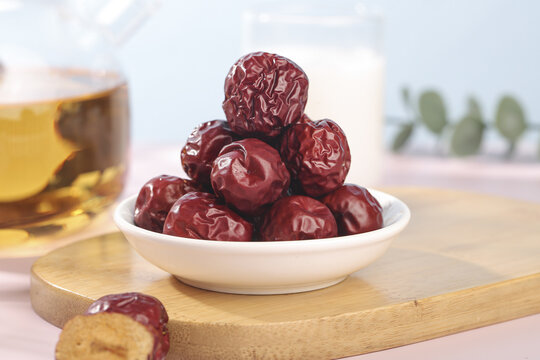 Dried Red Jujube Dates from Xinjiang Hami China in Bowl with Tea - Traditional Winter Healthy Snack