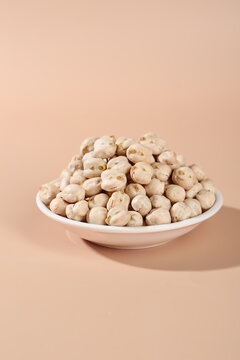 Crispy Fried Chickpeas in White Bowl - Healthy Xinjiang Snack on Beige Background