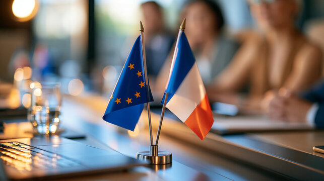 two desk flags standing on a bright conference table suggesting an alliance and agreement during a bilateral meeting, diplomacy and support concept, negotiation, international