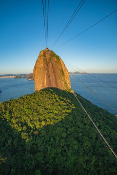 Sugarloaf Mountain with cable car wires in Rio de Janeiro, vertical Brazil travel background with copy space