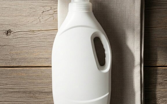 Laundry detergent plastic bottle mockup with white fabric on a wooden background for housekeeping and cleaning concept