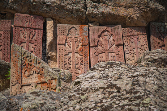 Stone carving on ancient Armenian khachkars in Geghard monastery, historic tufa texture with copy space