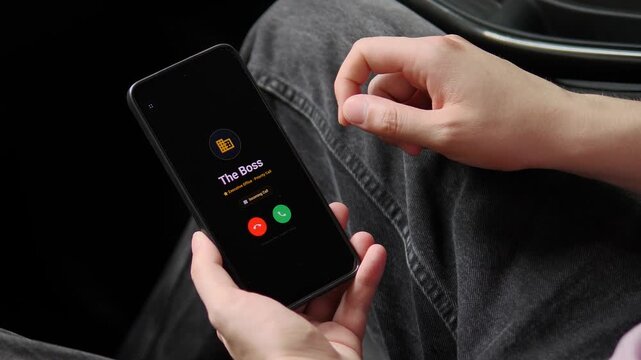 A priority business call lights up a smartphone in a parked car as the user answers and joins the conversation, capturing remote work pressure and always-on executive communication.