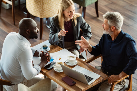 Business colleagues discussing strategy at a cafe